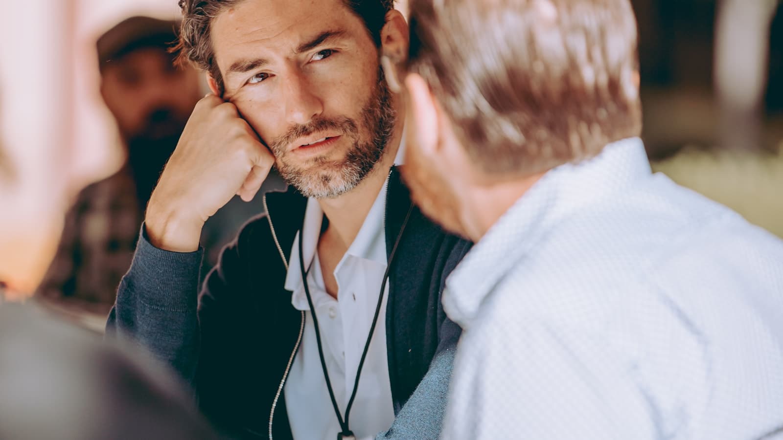 Two people talking with one person listening calmly